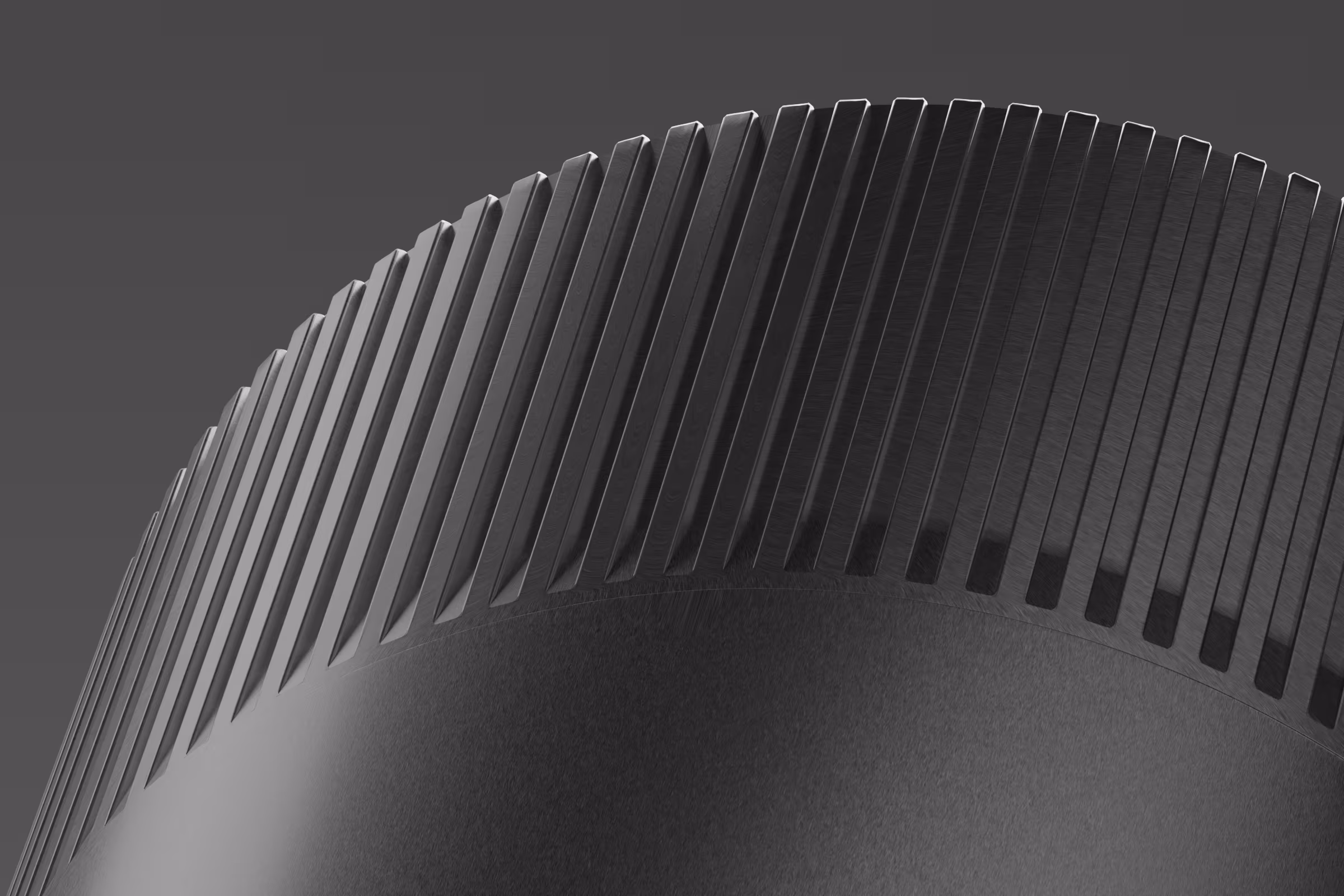 Close-up of a large black cylindrical object with evenly spaced vertical fins or ridges around its curved edge.