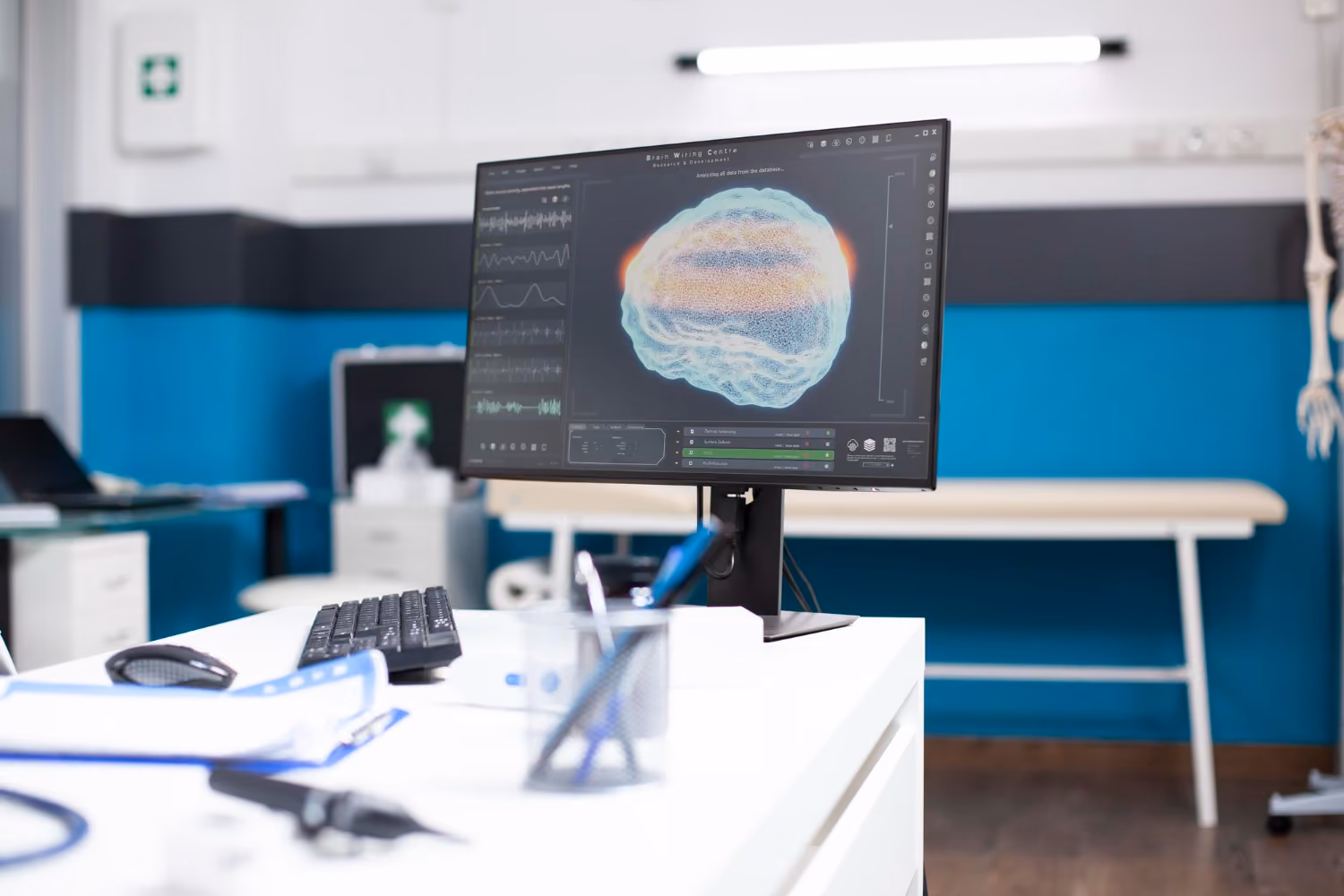 Computer monitor on desk displaying a colorful 3D brain scan with neurological data for Safety Management.