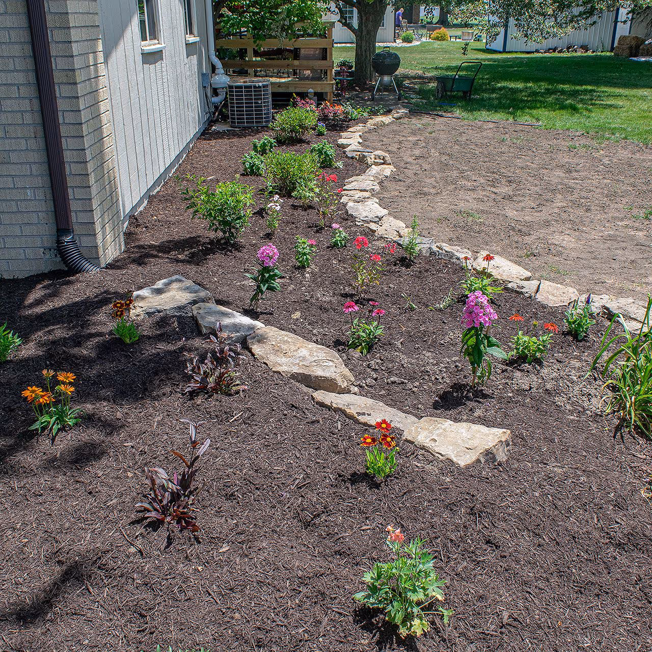Mulch and decorative rock installation for a home in Sullivan, Illinois