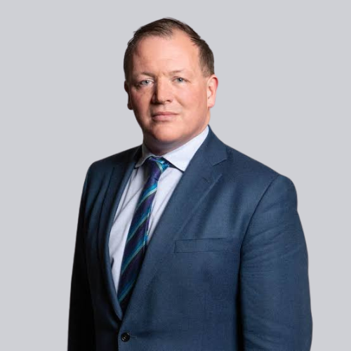 Mechanic in black gloves inspecting and repairing a car engine in a workshop.