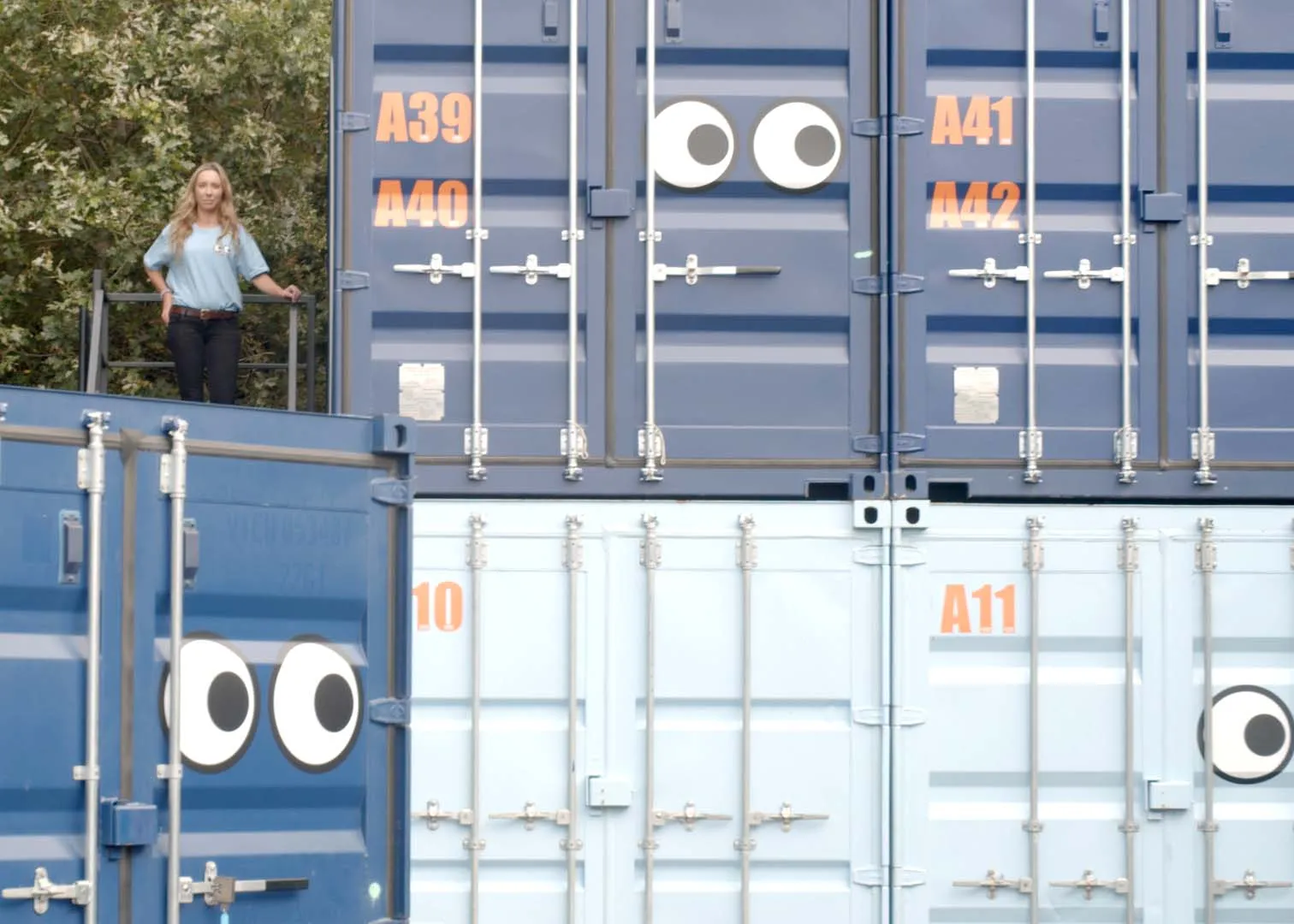 An image of a LOOK Self Storage team member on steps next to a storage container