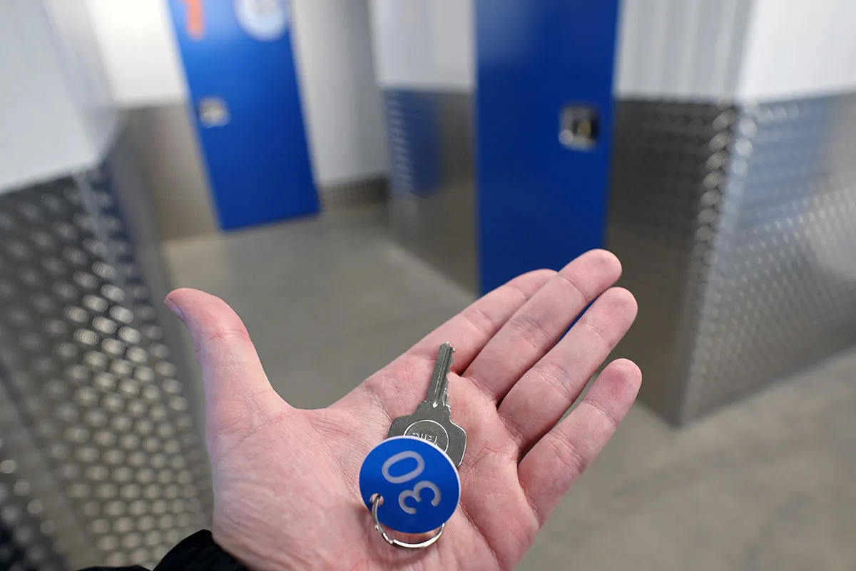 An image showing LOOK Self Storage units and a unit key