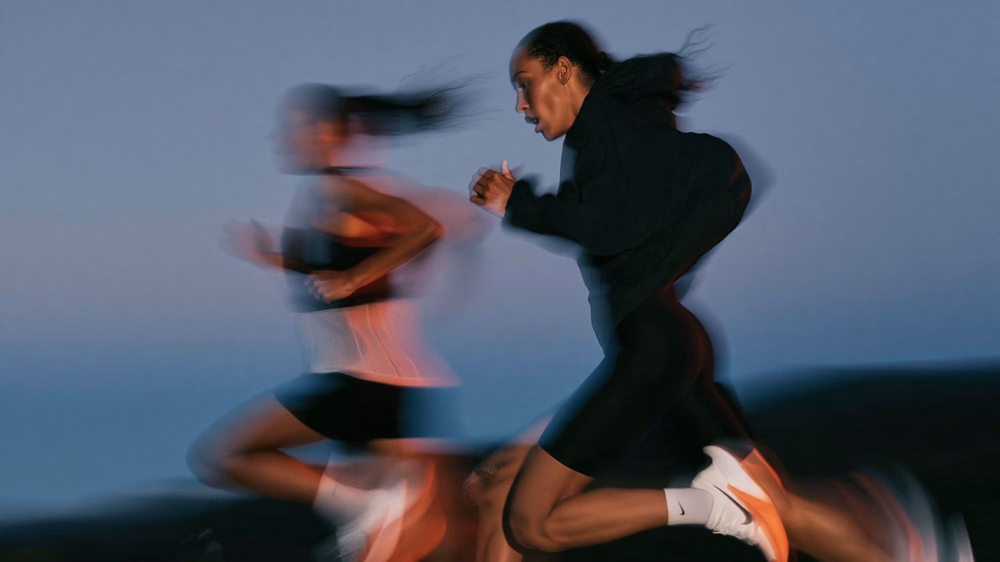 Blurred image of two runners in motion.