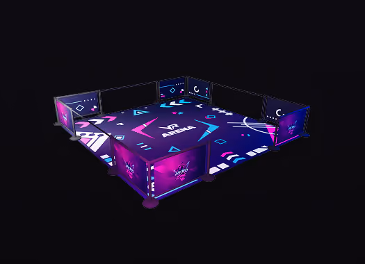 Indoor esports arena setup with illuminated barriers and vibrant geometric patterns on the floor and walls.