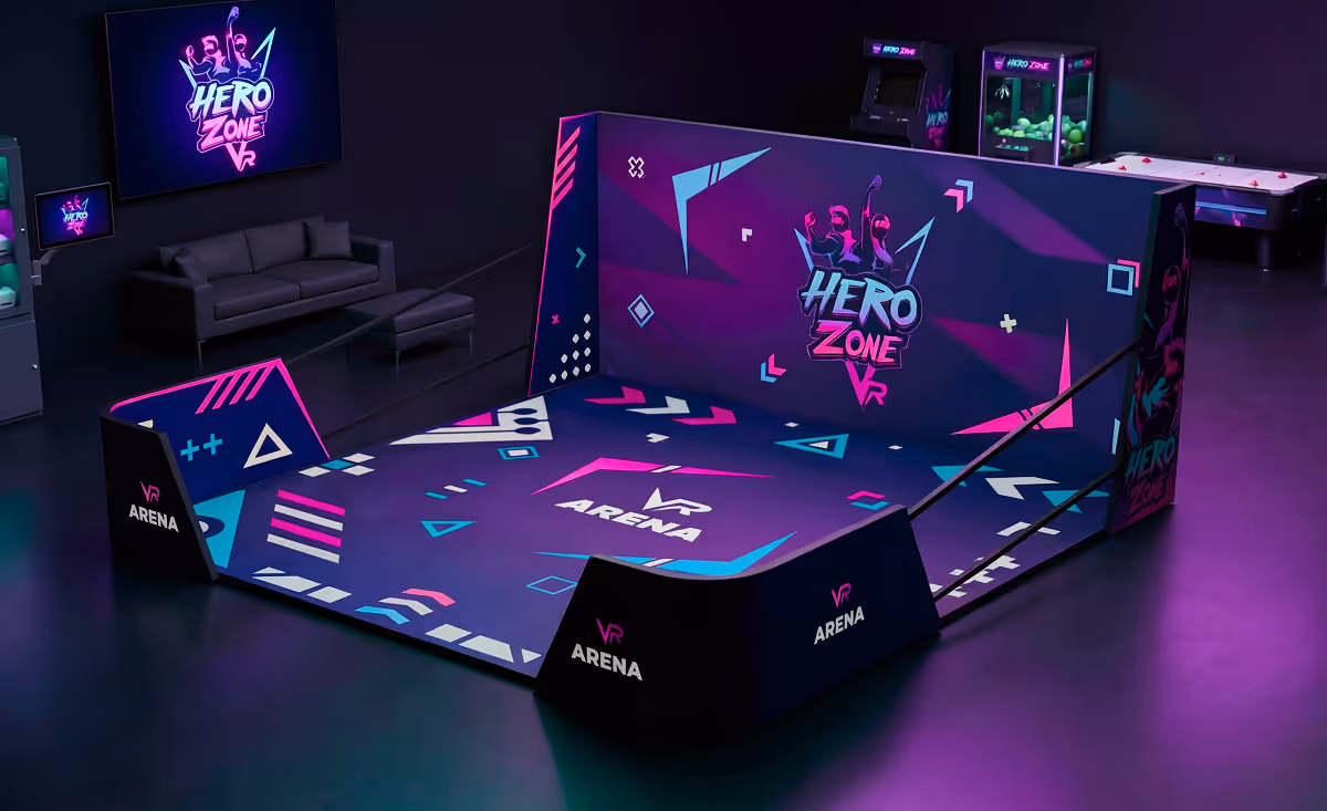 Neon-lit VR Arena branded with Hero Zone VR and VR Arena logos in a dark room with arcade games and a black sofa in the background.