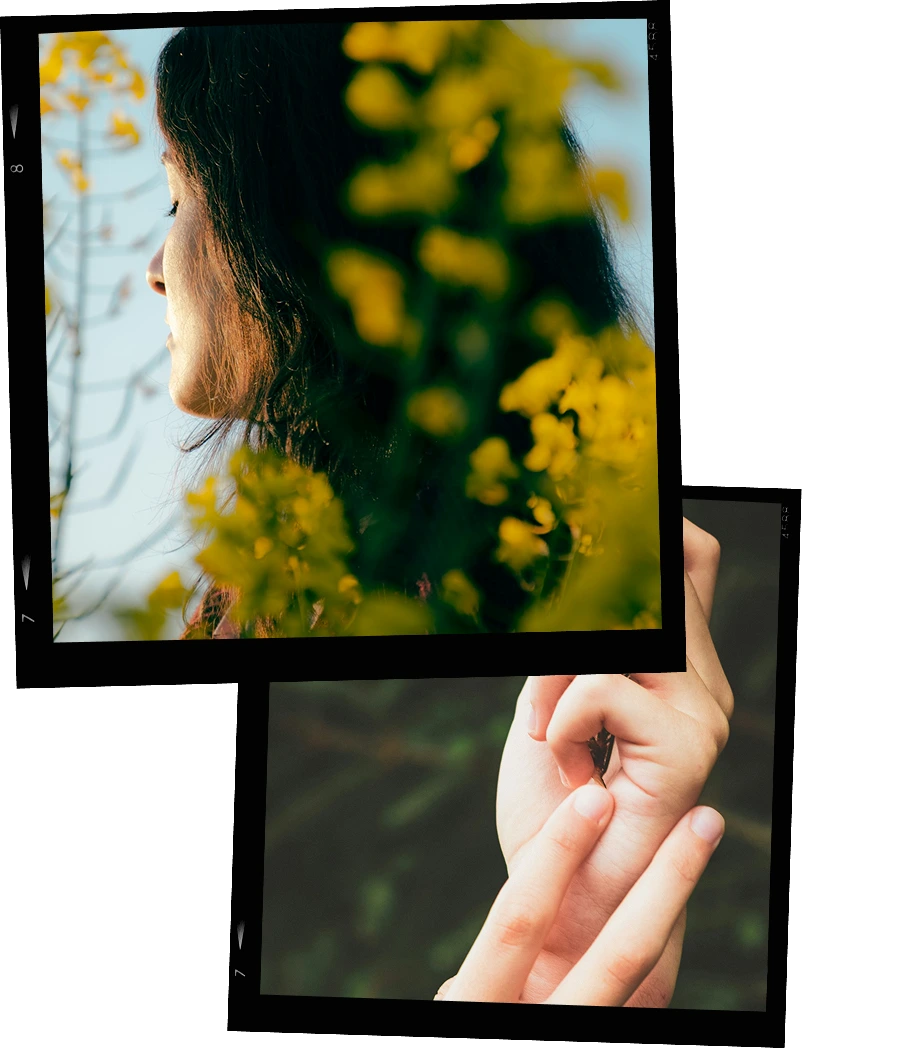 Close-up of a woman’s profile behind yellow flowers and a hand gently touching a small butterfly on another hand.