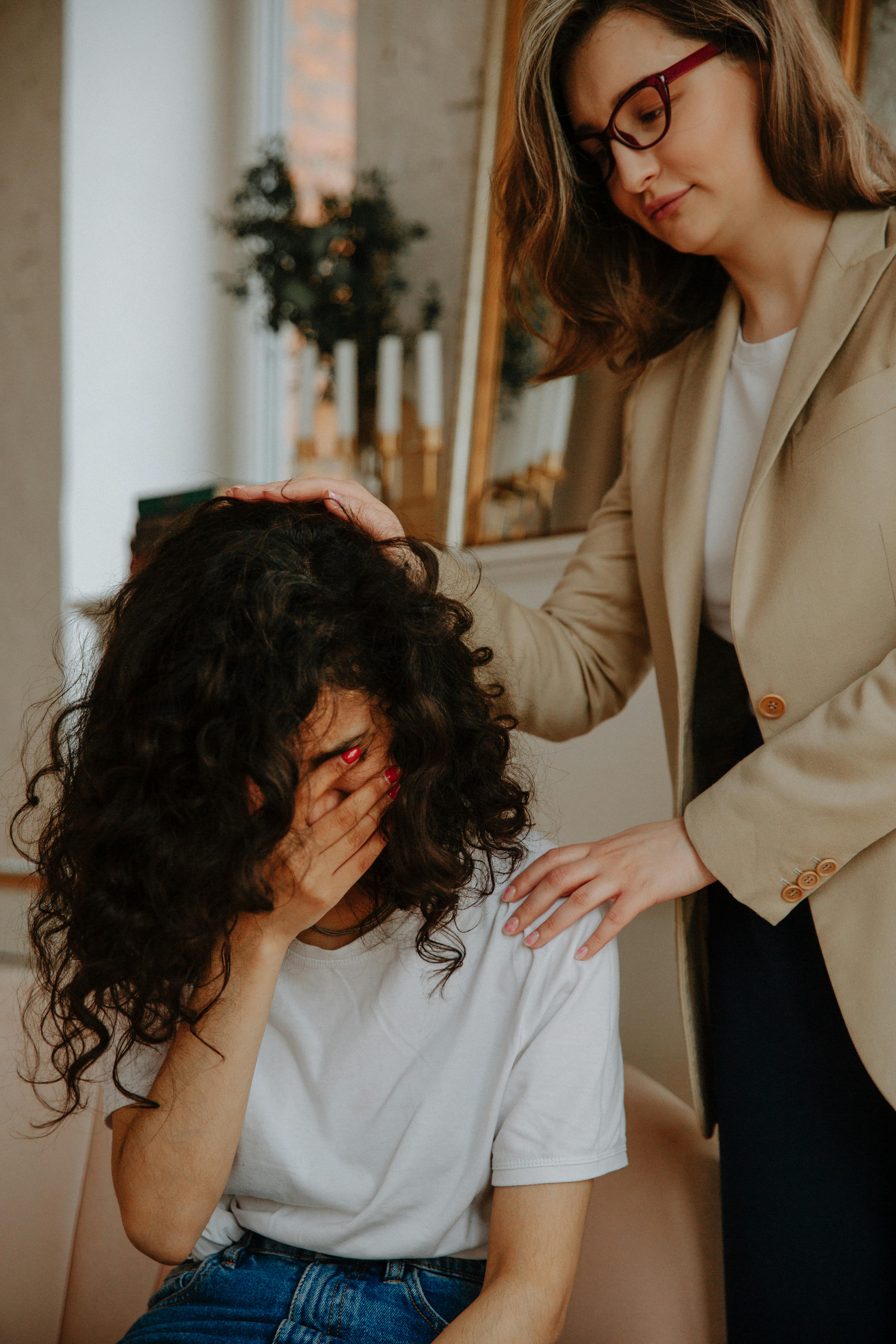 therapist supporting her patient 