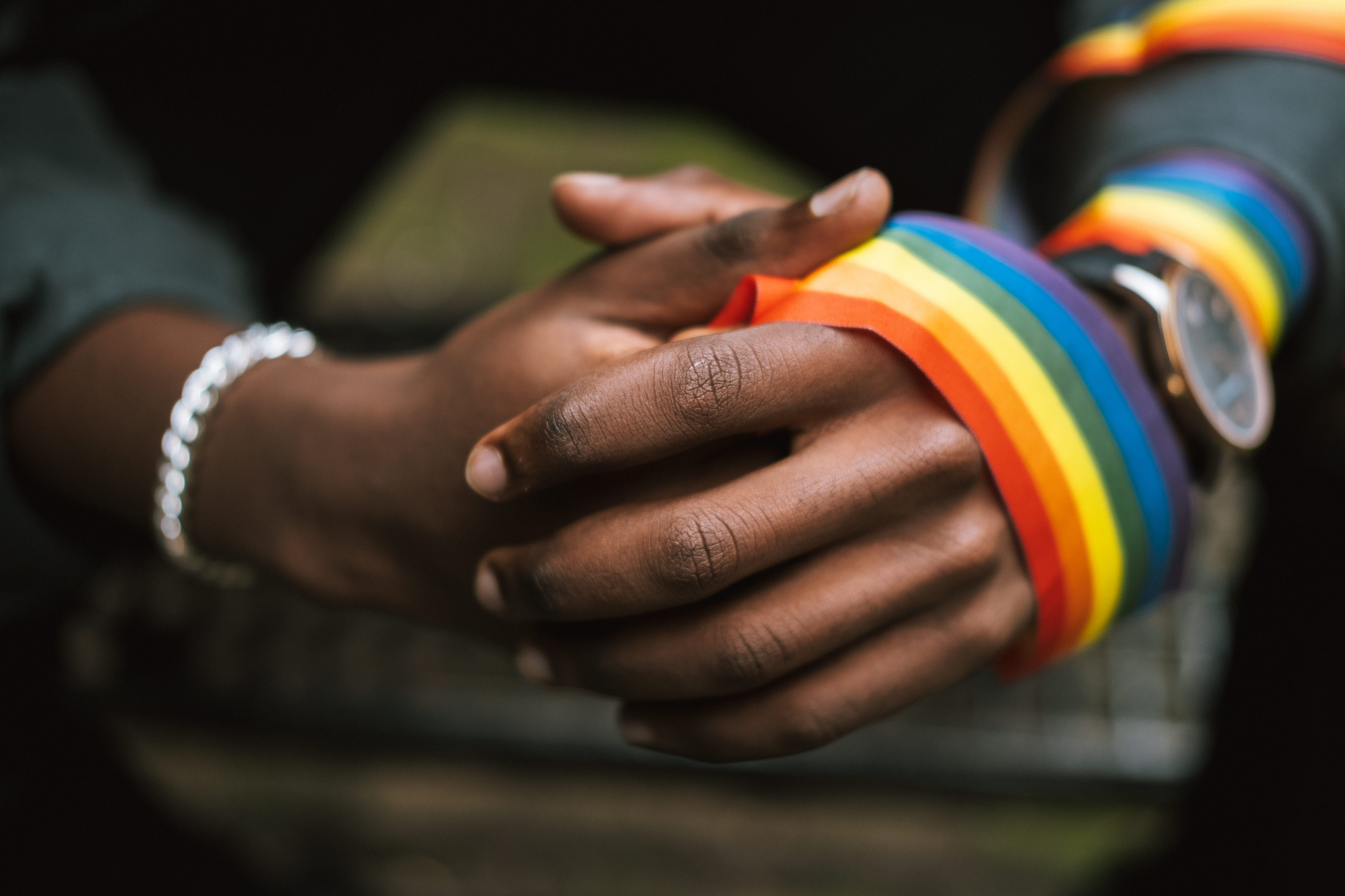 hands wrapped in rainbow fabric