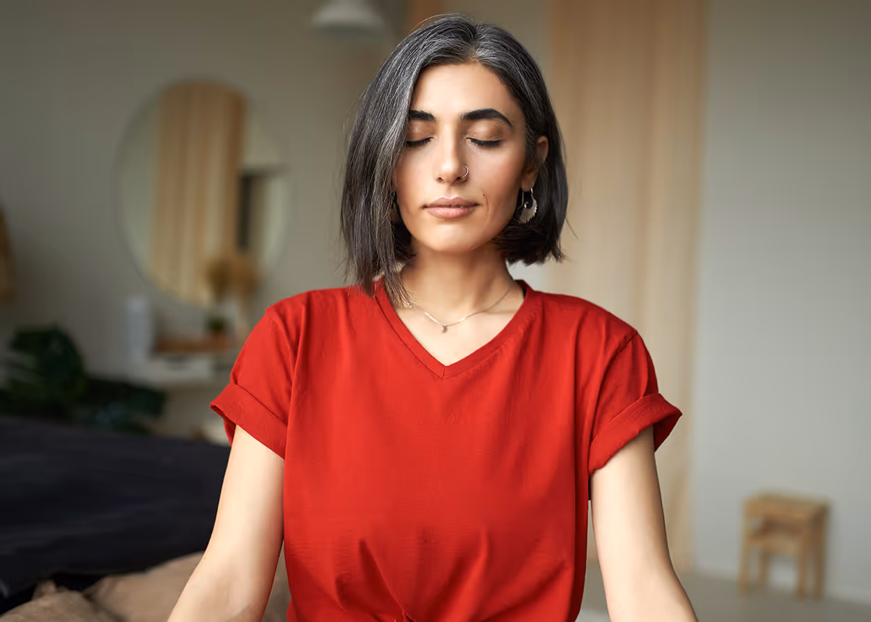 Calm woman practicing breathing exercises for the blog From Stress to Steadiness: 3 Grounding Techniques by Willow & Stone Counseling in DFW.
