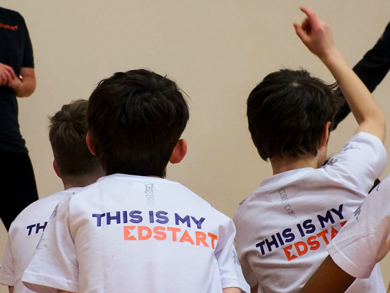 A group of kids in a sports class wearing Edstart T-shirts.