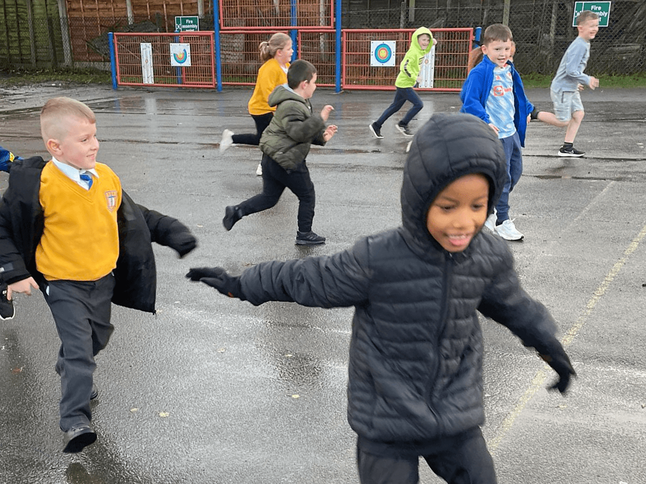 School children playing tag in the playground.