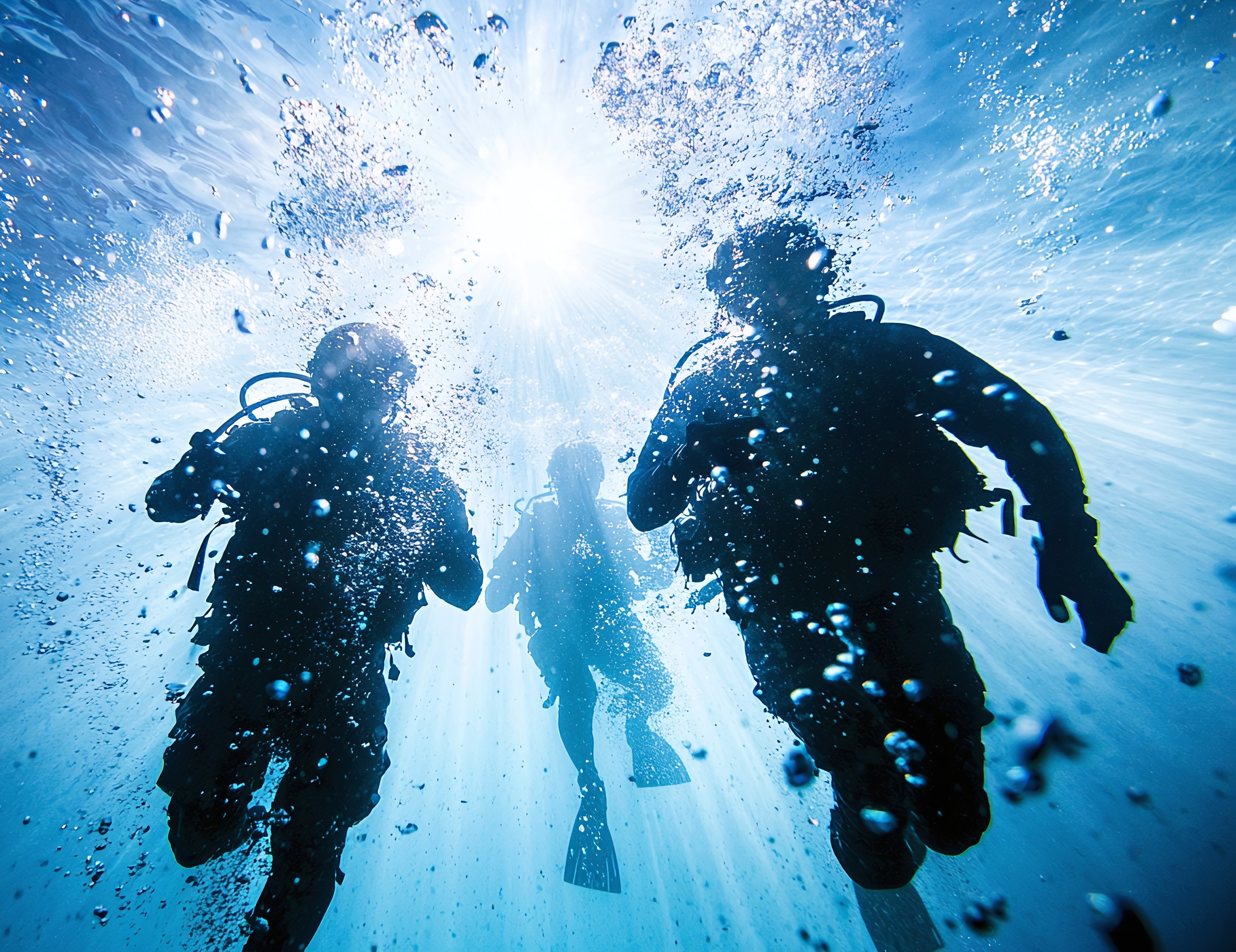 Divers navigating underwater in an extreme subsea environment, representing human performance research in undersea operations