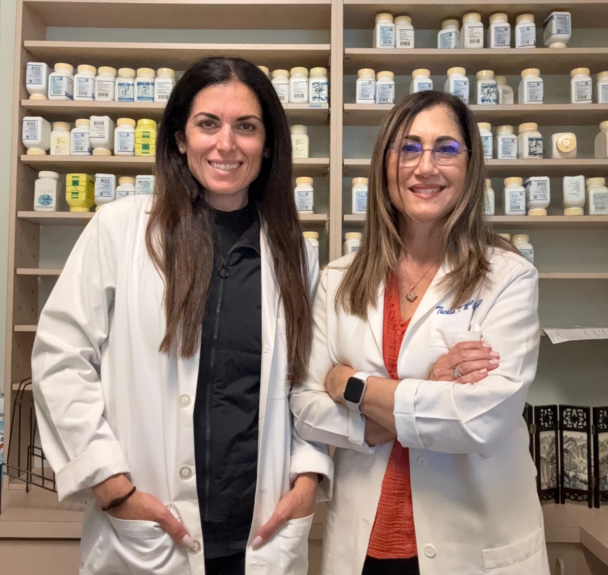 Theresa McIntosh and Jenna Vilardo in white coats - Acupuncture Associates of Plantation