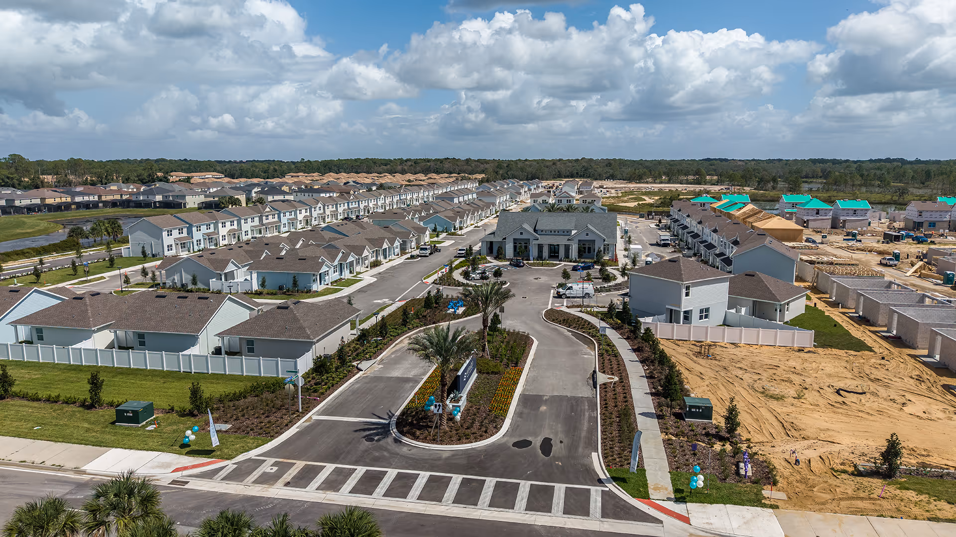 Aerial view of a new suburban housing development with completed homes and ongoing construction.