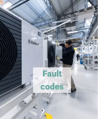 A picture of the Vaillant manufacturing plant with an engineer doing work on an Arotherm Plus, with the text fault codes