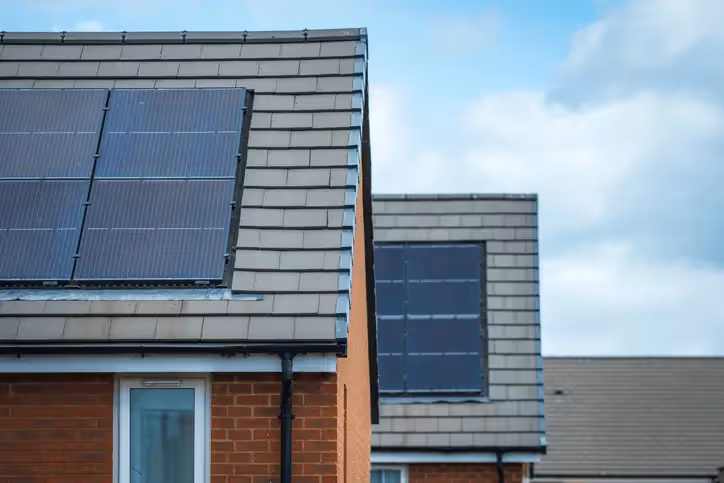 A picture of solar panels on 2 different houses