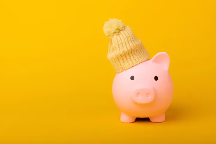 Illustration of a piggy bank with a yellow bobble hat