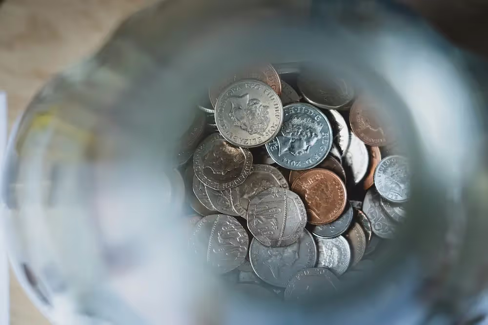 Photo of various coins in a jar