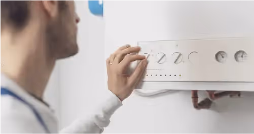 Man turning the temperature of their boiler down