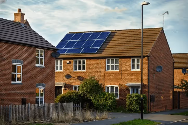 A semi detached house with solar panels on it