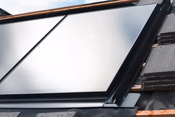 A solar panel integrated flush with a roof