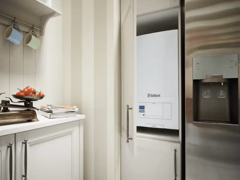 A Vaillant ecoFIT Pure boiler in the kitchen, wall mounted next to a fridge