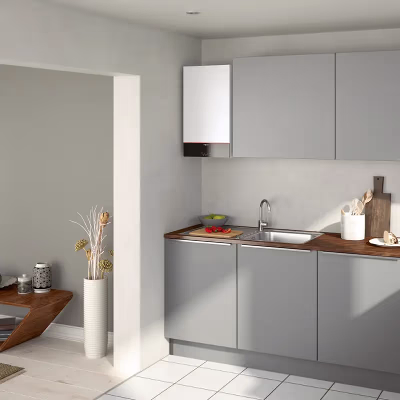 Viessmann Vitodens 100-W combi boiler on the wall of a kitchen alongside grey cupboards