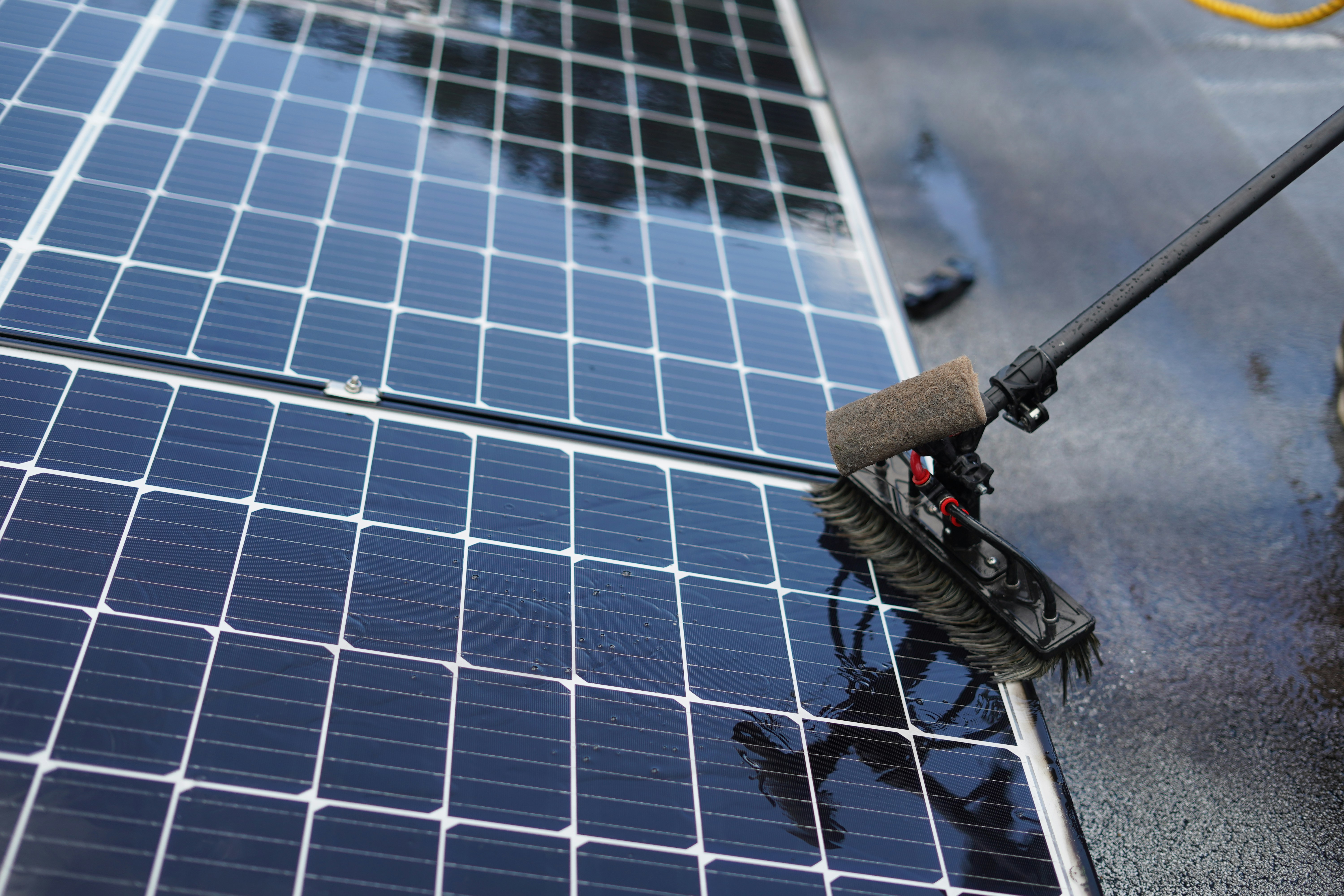 Solar panels on a roof being cleaned