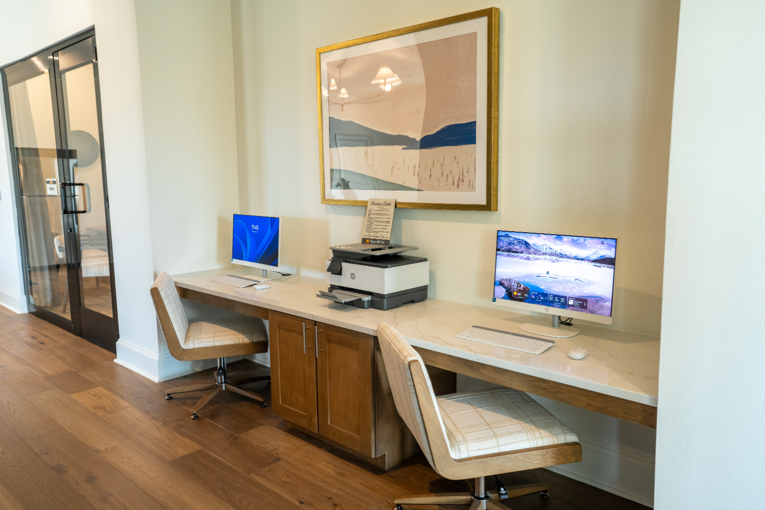 Business center with desks, computers and printer
