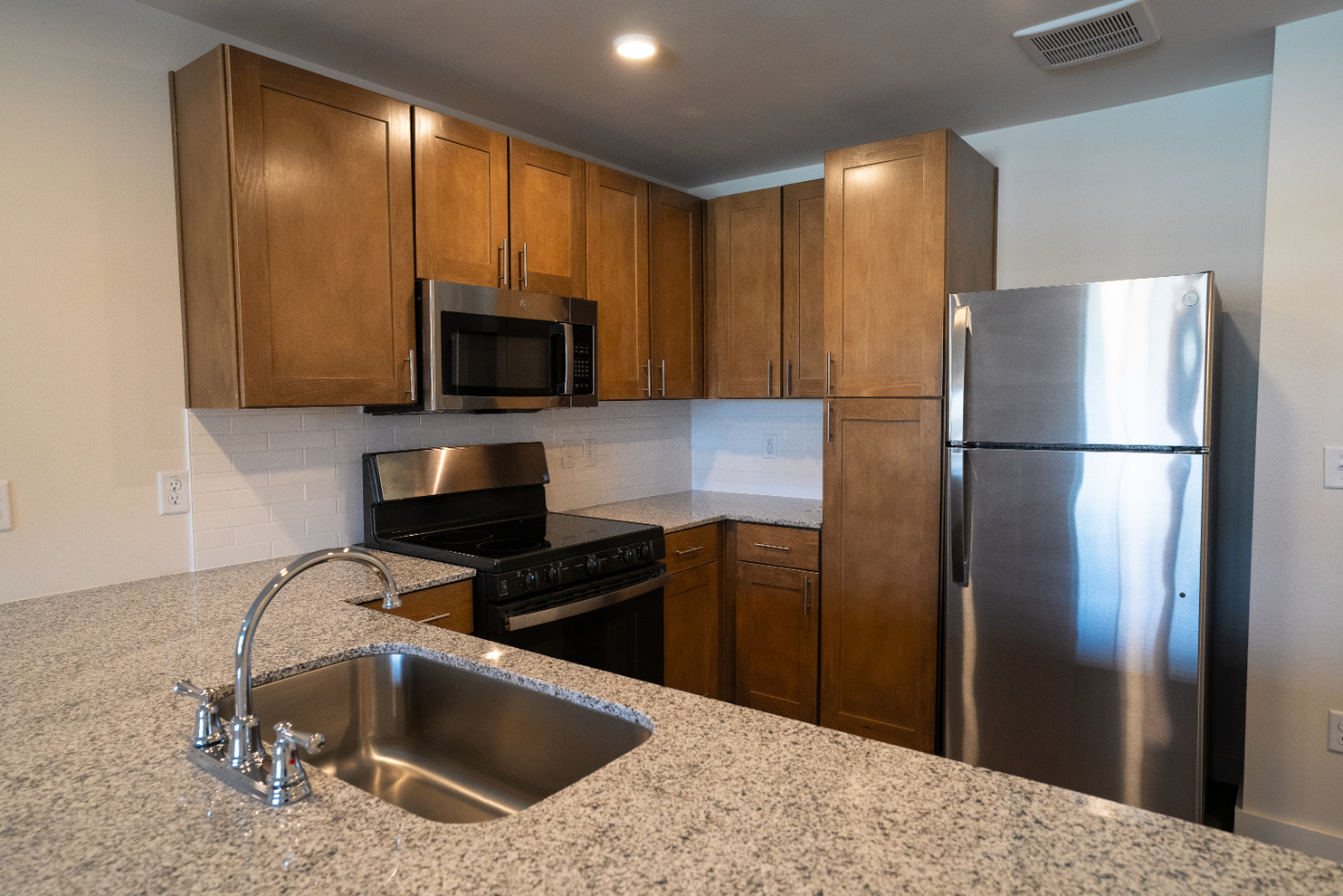 Kitchen with stainless steel appliances and brown cabinets 