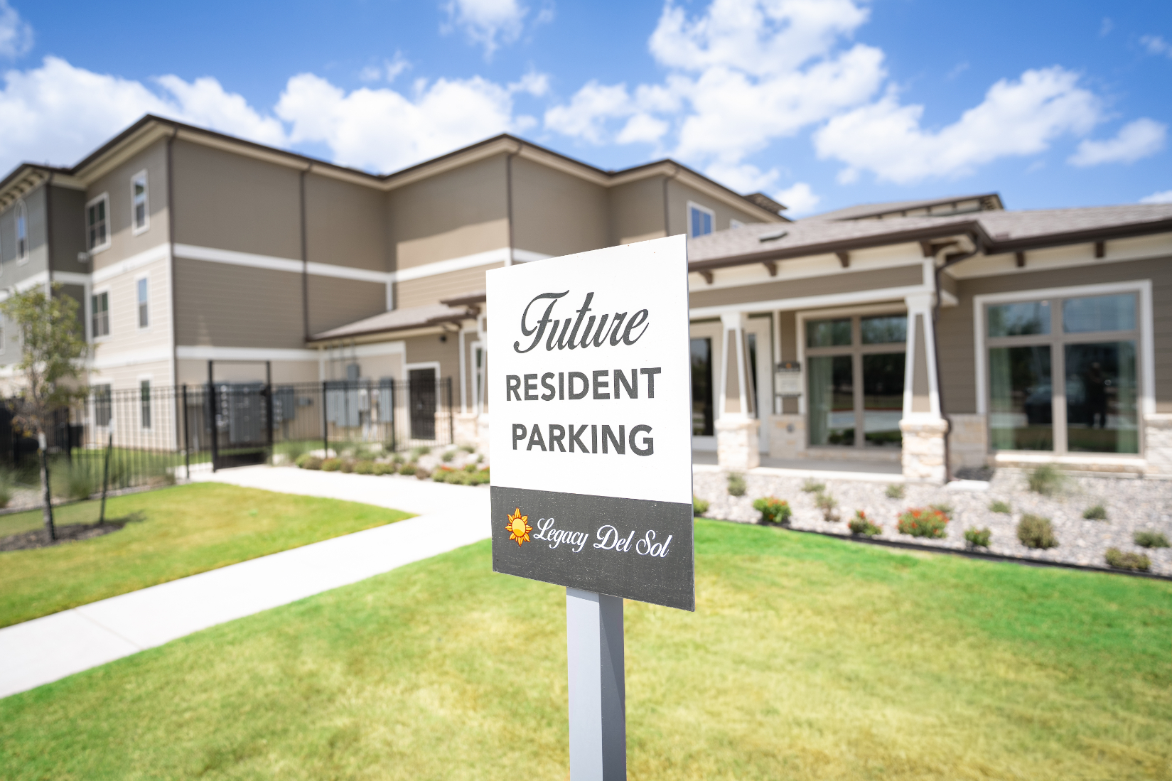 Exterior with parking sign outside of leasing office