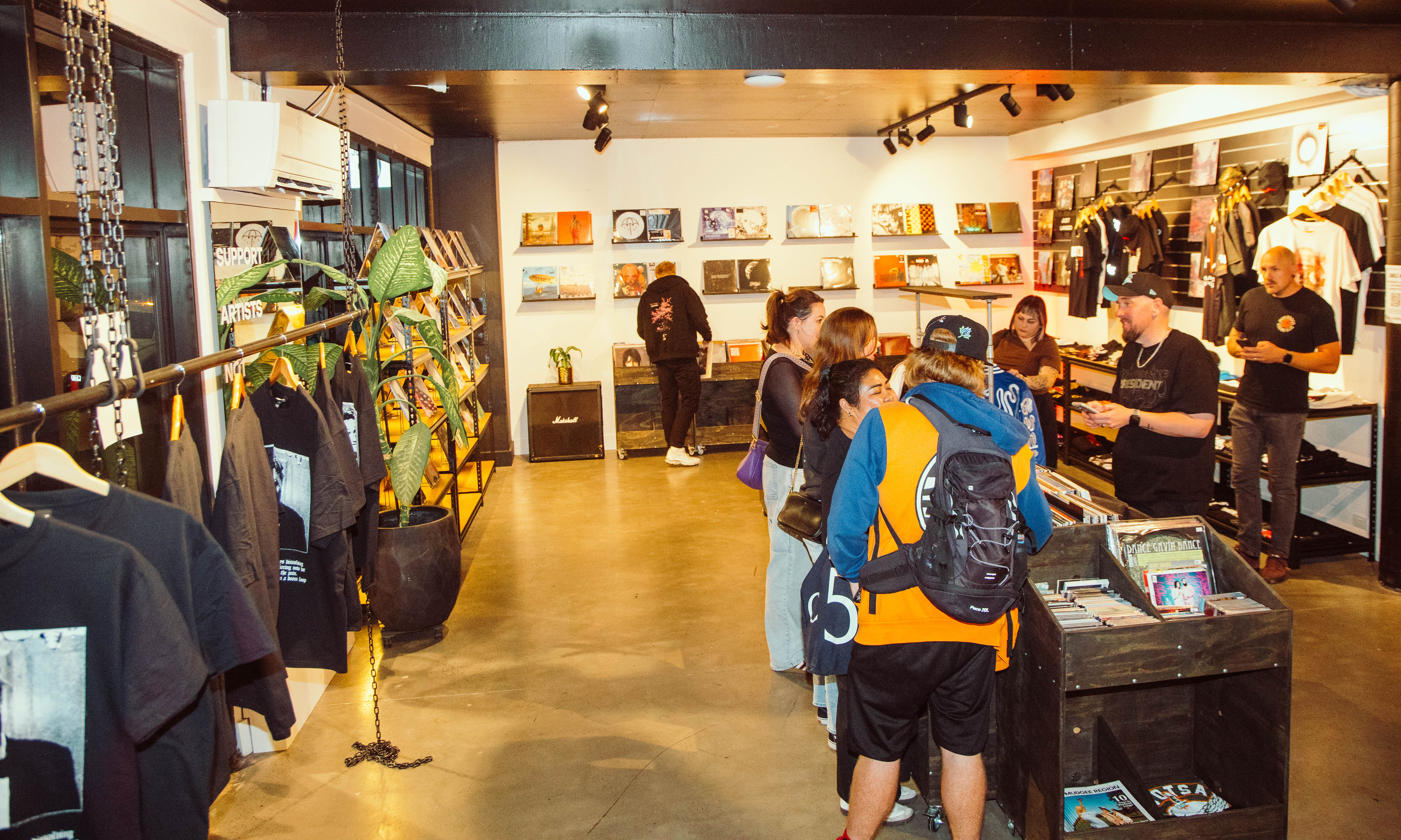 Music fans browsing records and merchandise inside Jungle HQ