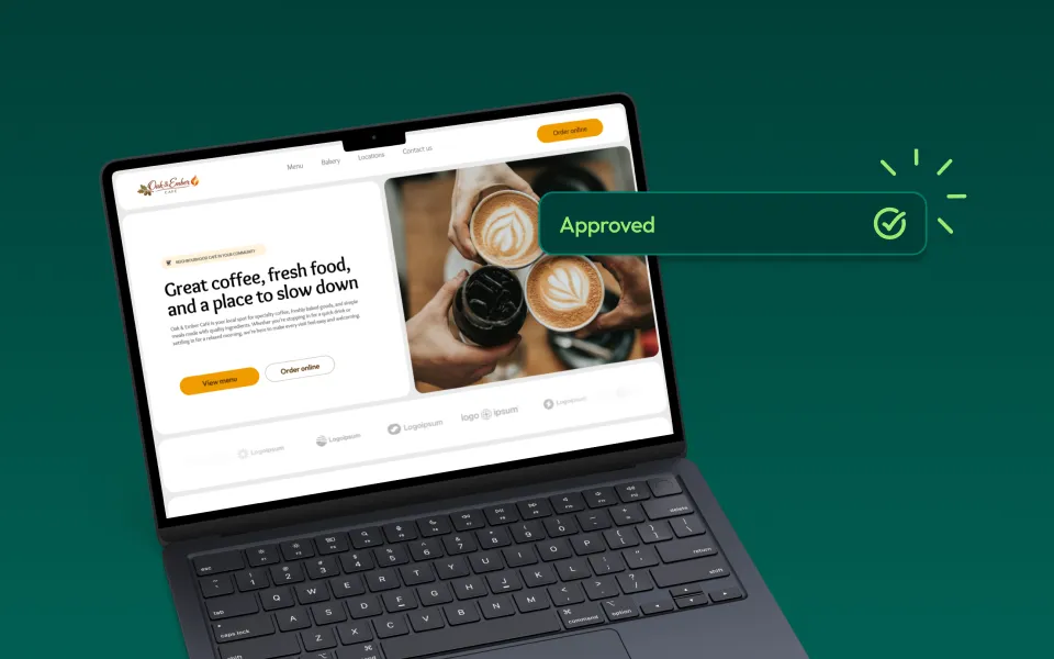 Laptop showing a coffee shop website with text describing fresh coffee and a place to slow down, alongside hands holding latte art cups and an approved confirmation message.