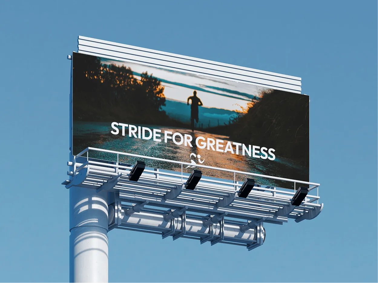 A billboard with blue sky background. The billboard shows someone running away through a mountain range with the phrase "Stride for greatness".
