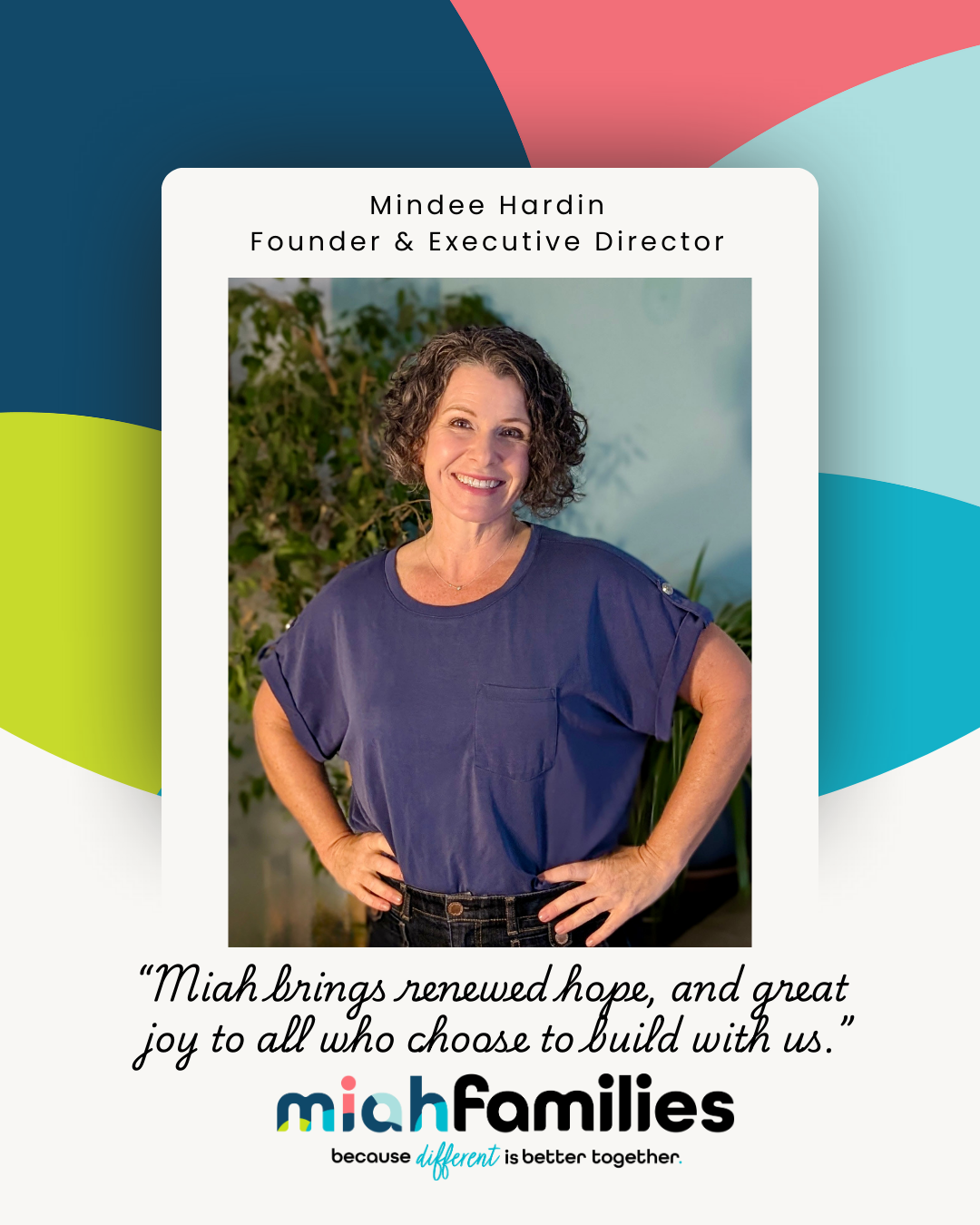 Smiling woman with short curly hair wearing a patterned shirt and textured cardigan.