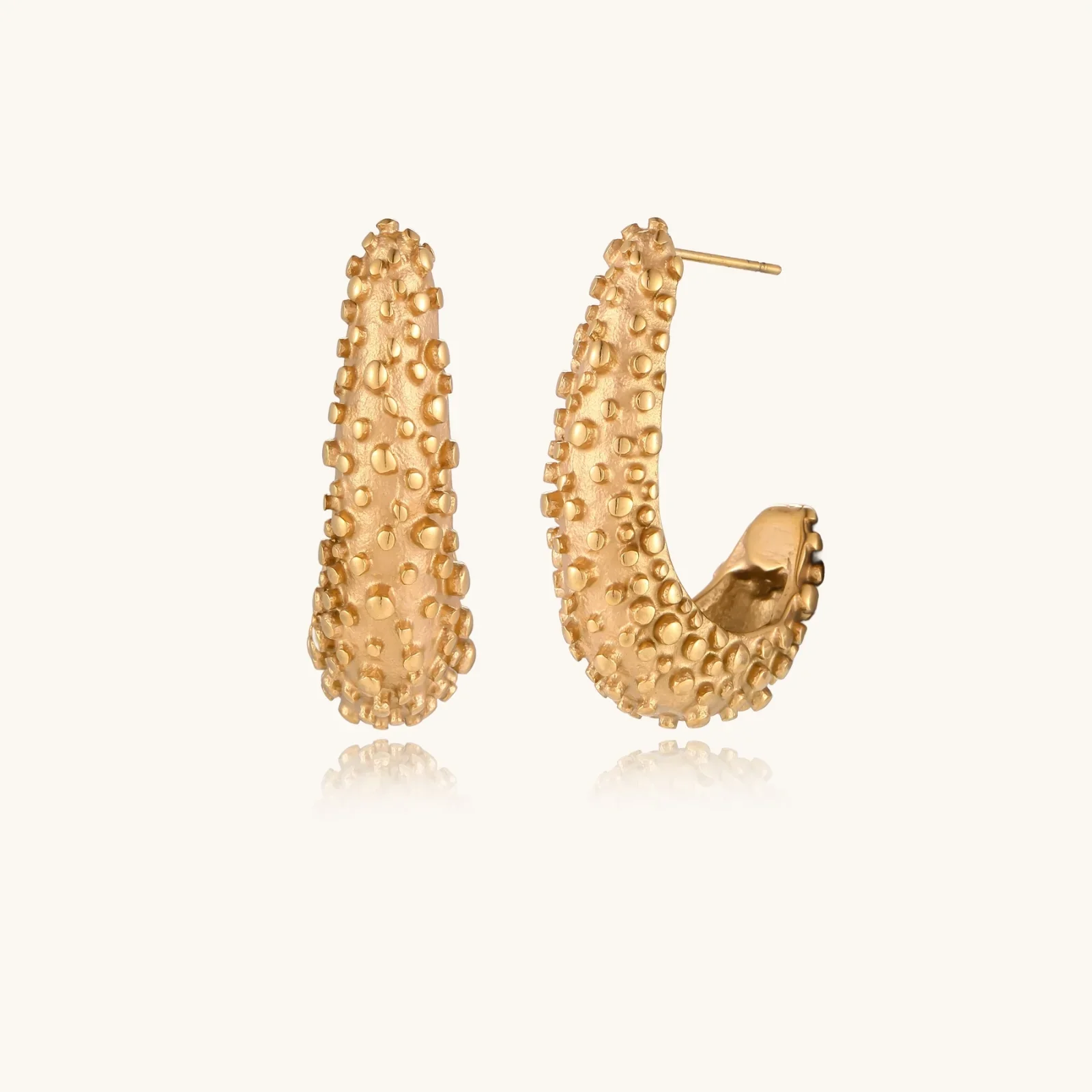 Product thumbnail: gold hoops and layered chains on a model.