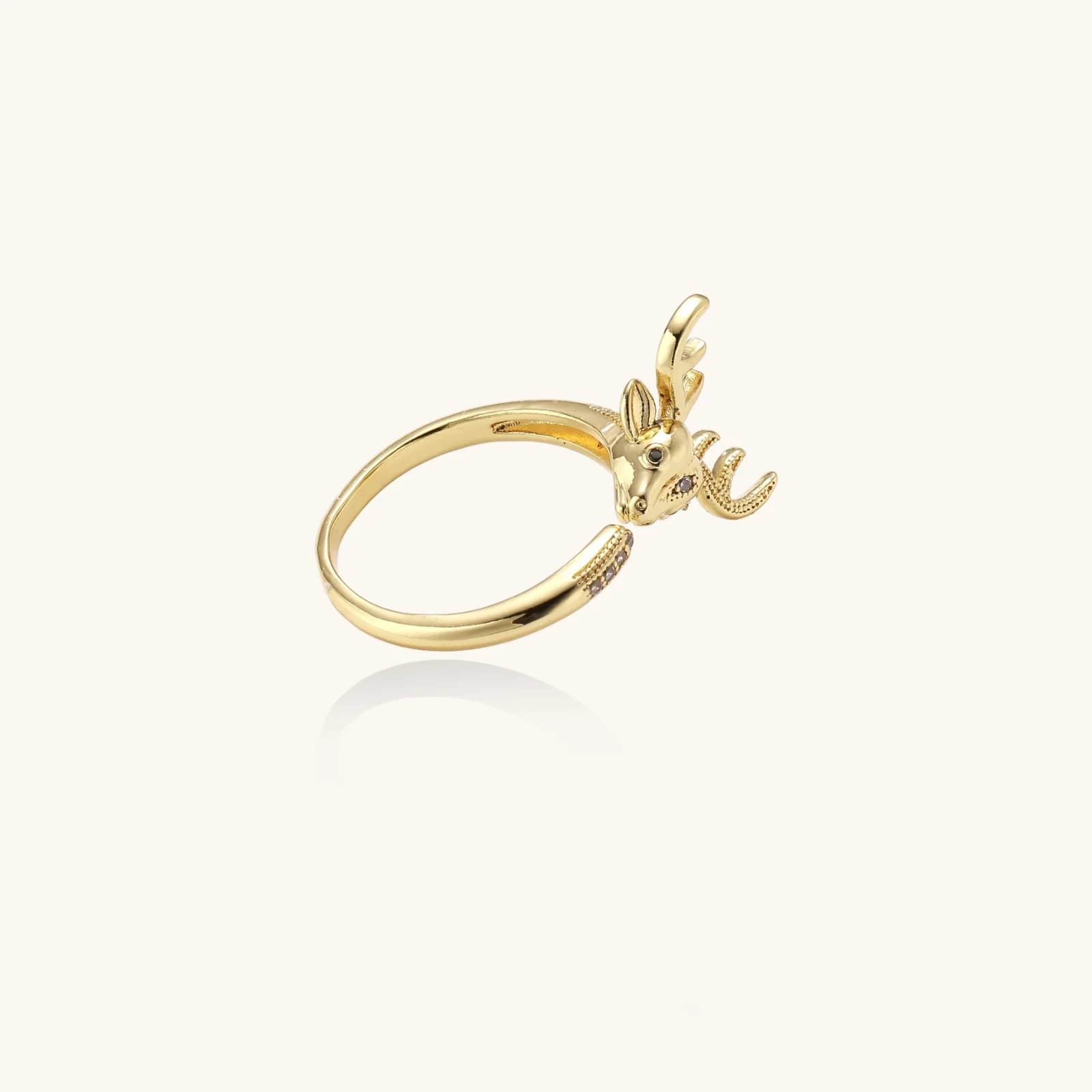 Gold ring featuring an open design with a detailed deer head and antlers.