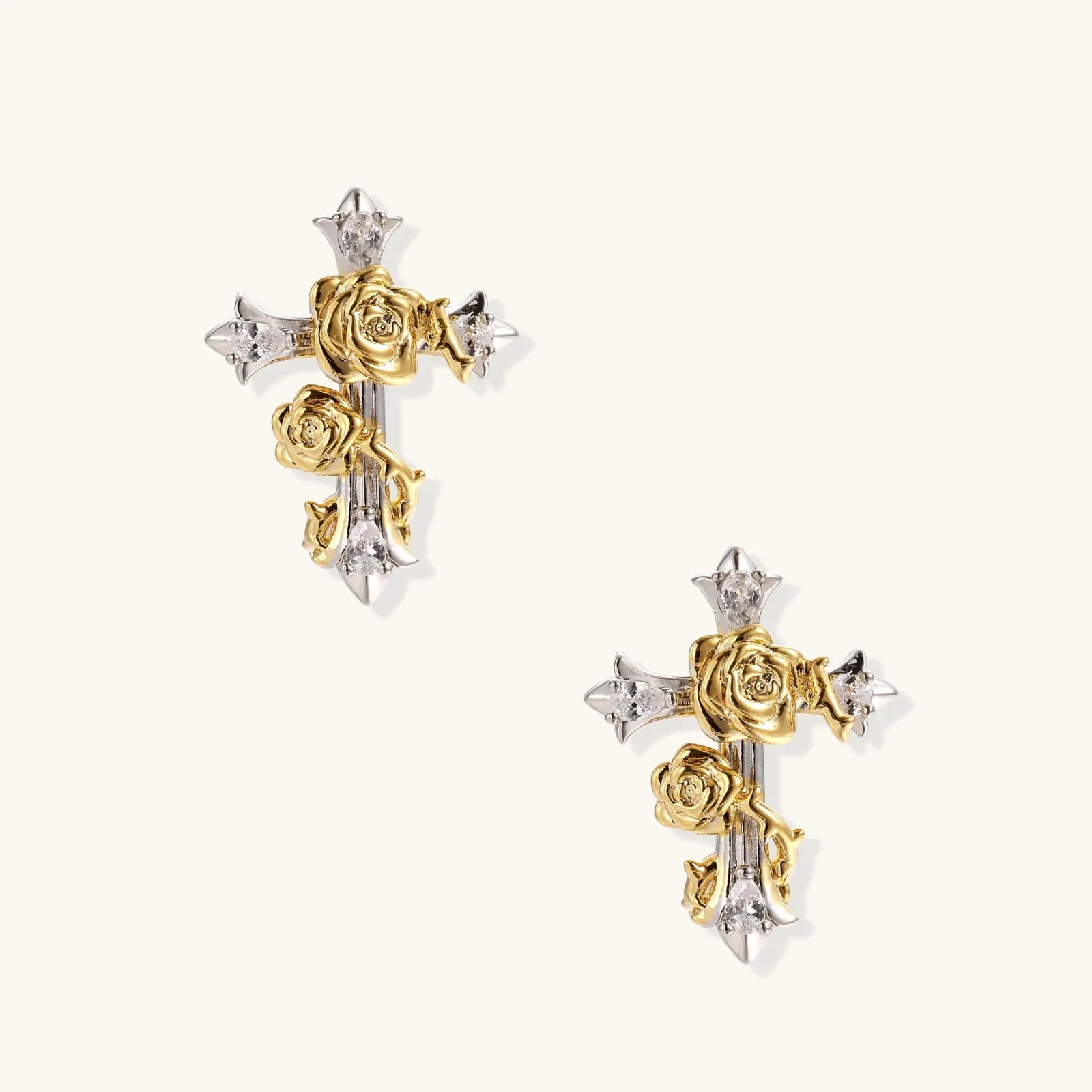 Pair of silver cross earrings decorated with gold roses and small diamond accents.