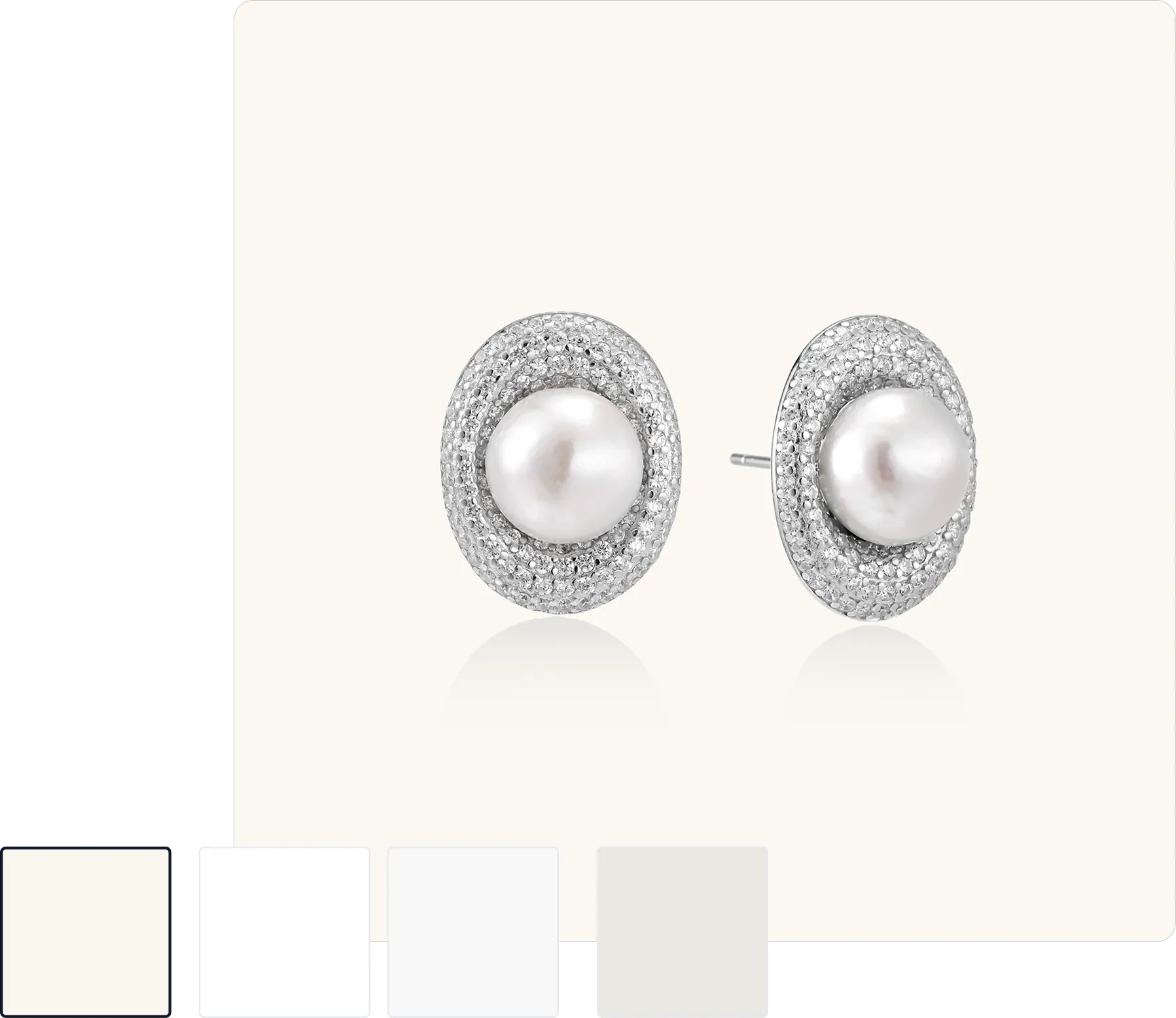 Pair of silver stud earrings featuring a central white pearl surrounded by small clear gemstones.