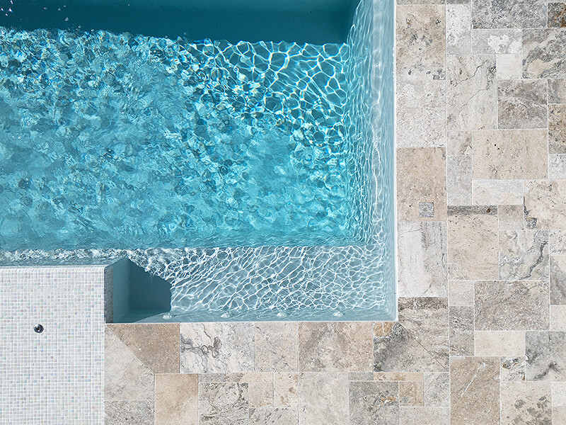 Custom pool construction with sleek edges and clear blue water