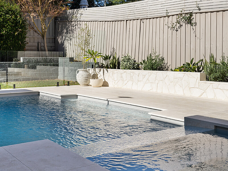 In-ground swimming pool with modern finishes and outdoor patio