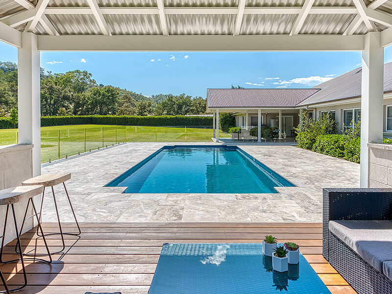 Family-friendly backyard pool with shallow entry and seating area