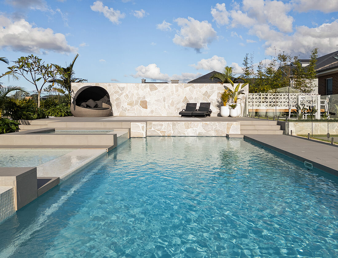 Family-sized fibreglass pool with surrounding deck and garden