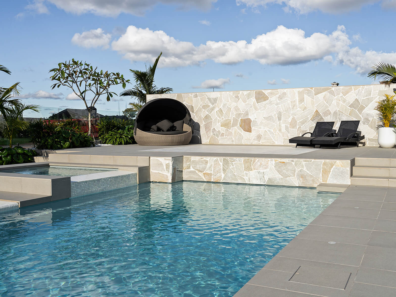 Backyard pool built for relaxation with landscaped garden setting