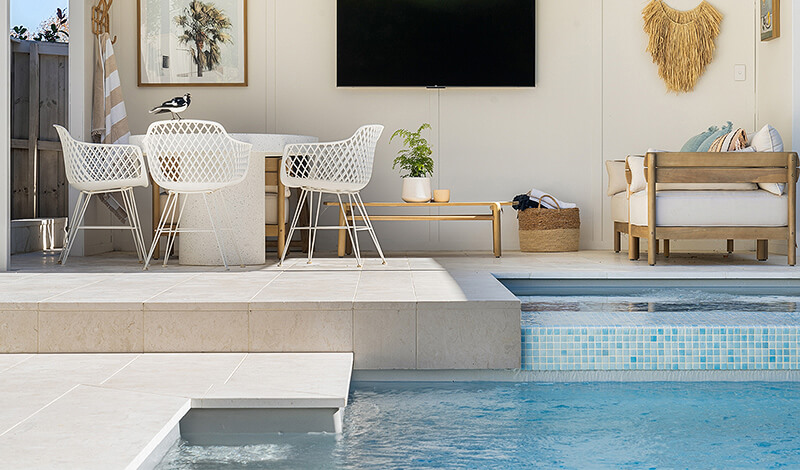 Entertaining area on pool edge in dream backyard