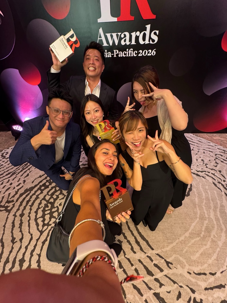 Group celebrating with trophies at the PR Awards Asia-Pacific 2026