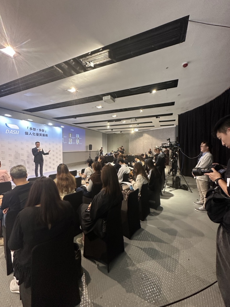Presenter speaking to journalists at a DASH media event