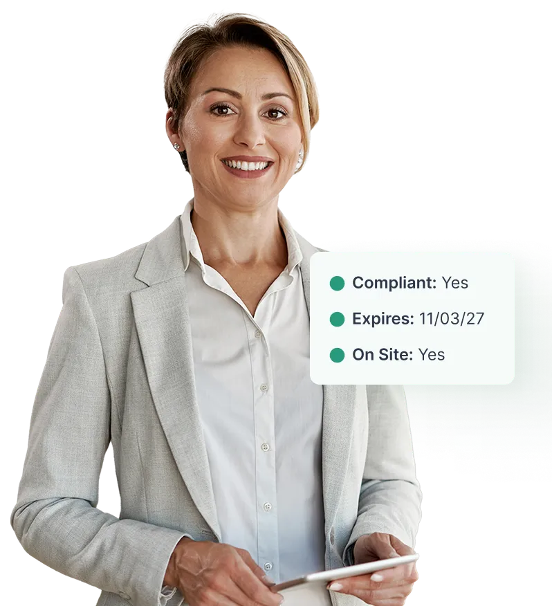 Property manager with tablet reviewing vendor compliance status showing compliant, active, and on-site vendor confirmed in NetVendor