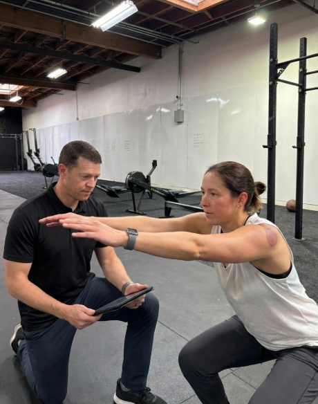 Patient working with a provider at a performance physical therapy clinic in Oakland during functional movement assessment