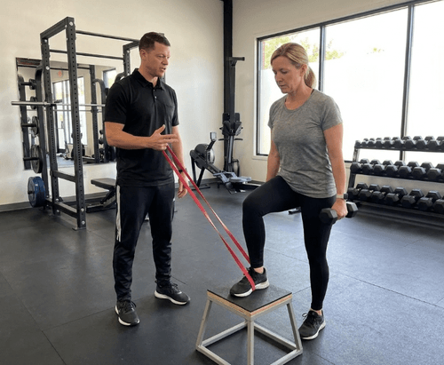 Patient working with a provider at a sports physical therapy clinic in Oakland, CA during a lower extremity strengthening session